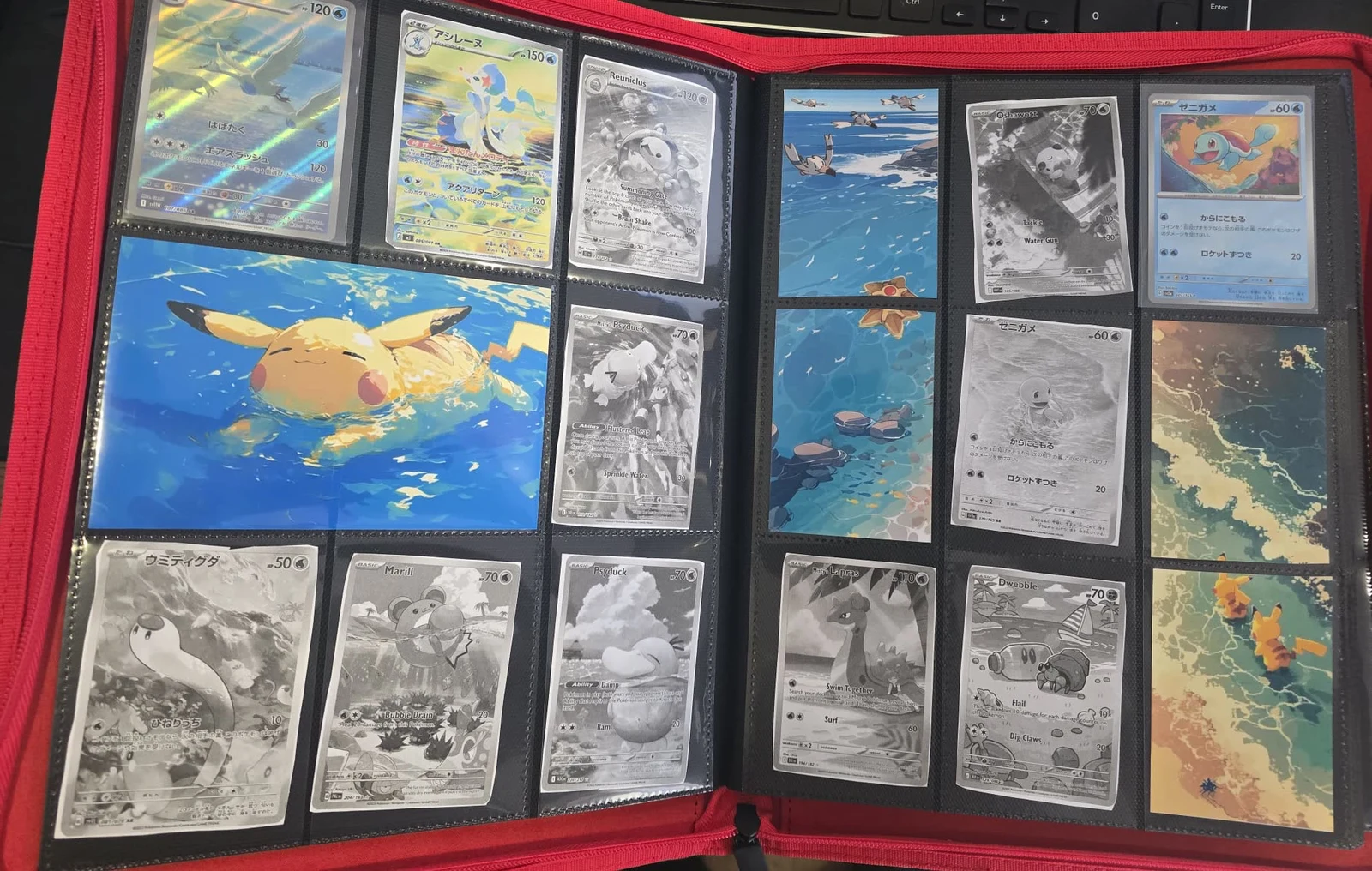 A printed beach-and-underwater themed Pokémon binder spread in a physical binder.